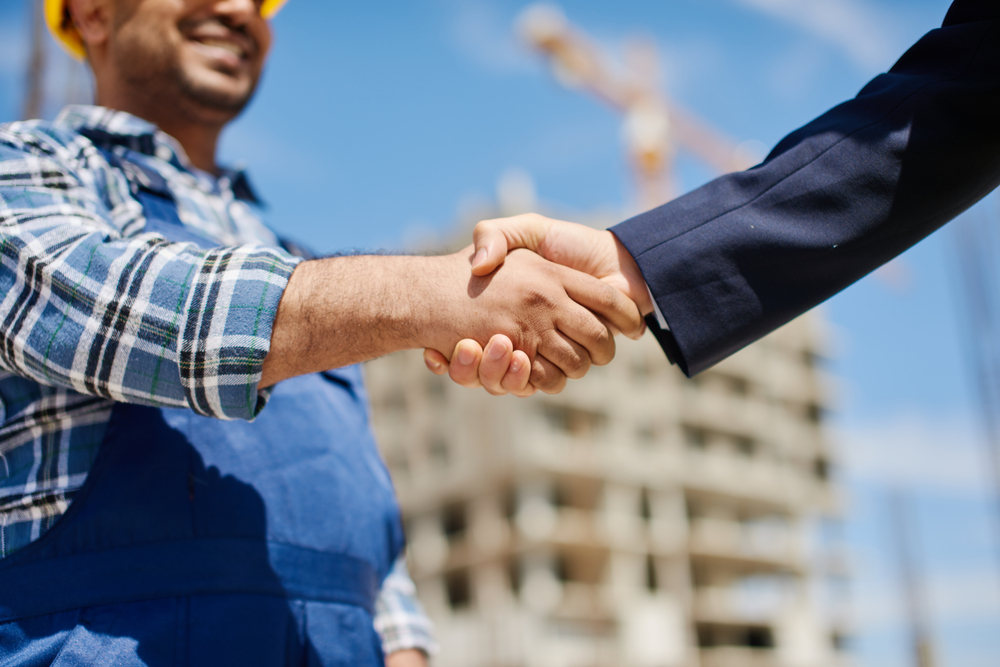 Real estate investor and contractor shaking hands